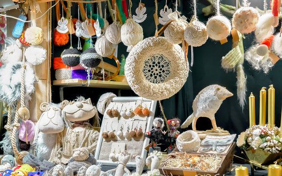Linen bird statue, wreaths and accessories at stalls of Christmas market in old Riga, Latvia. Europe on winter. Street Xmas and holiday fair. Advent Decoration and Stalls with Crafts Items on Bazaar