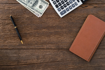 Top view workspace office with smartphone and money and blank notebook