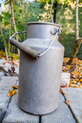 Old milk churn in a yard