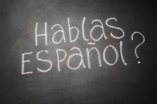 Spanish Language Learning Concept. Inscription HABLA ESPANOL On Blackboard.