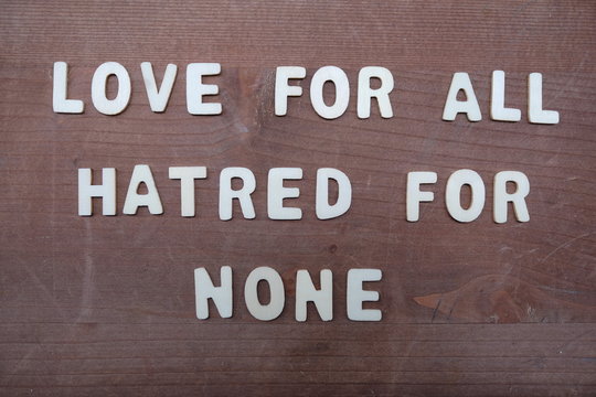 Love for all, hatred for none, peace quote phrase composed with wooden letters 