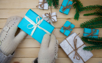 Christmas toys with fir branches on a wooden table, gift box, empty place, New Year concept. View from above.