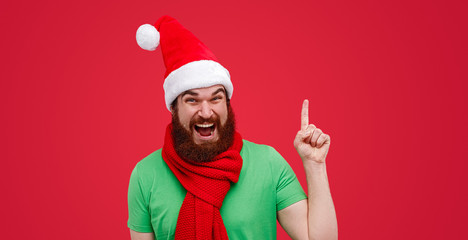 Excited Christmas elf pointing up