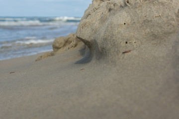 Fototapeta na wymiar coastal abrasian on a small sandy wall