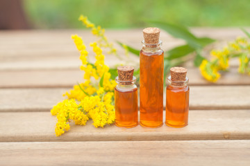 goldenrod essential oil in  beautiful bottle on table