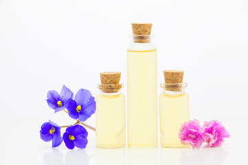 Fototapeta na wymiar violet essential oil in beautiful bottle on White background