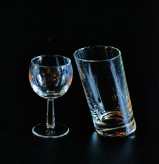 Glass and inclined glass on a black background