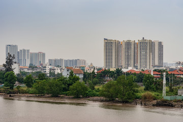Ho Chi Minh City Vietnam - March 12, 2019: Song Sai Gon river. Development of better housing and high rise apartment buildings with green foliage between Thanh My Loi and Binh Trung Tay.