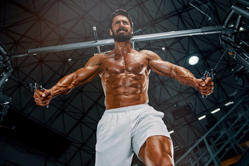 Fototapeta na wymiar Handsome Muscular Men Exercise At the Gym