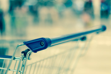 Naklejka premium Shopping cart close up. vintage filter