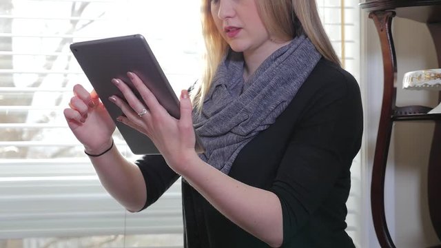 Revealing A Young Blonde Female Inside Sitting Swiping iPad Tablet