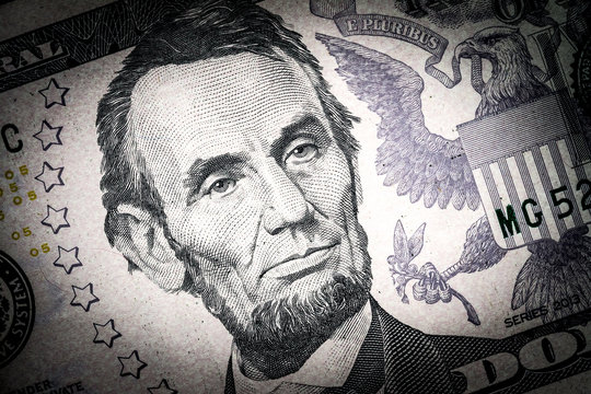Close-up portrait of Abraham Lincoln on a 5 US dollars banknote.