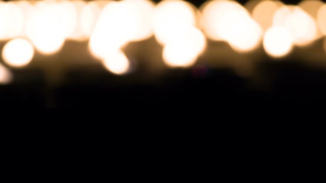 Fading Candles Fire. A field of burning candles close up. Candles begin to fade from the camera into the distance. Filmed at a speed of 120fps
