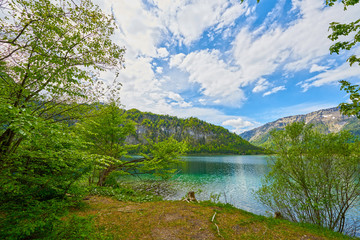 Naklejka na ściany i meble Beautiful Offensee lake landscape with mountains, forest, clouds and reflections in the water in Austrian Alps. Salzkammergut region.