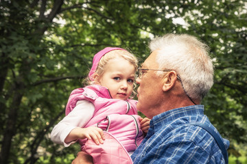 Happy senior grandparent holding grandchild togetherness grandparenting concept