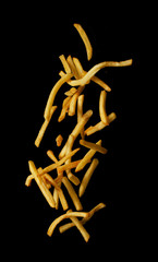 French fries flying in the air isolated on black background