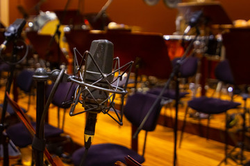 Microphone with a stand close up. Musical instruments of the Orchestra in philharmonia.