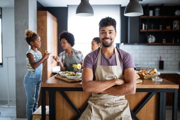 Fototapeta premium Happy family cooking together food in the kitchen