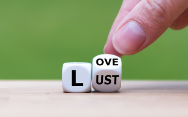 Hand turns a dice and changes the word "lust" to "love", or vice versa.