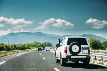 SUV Car Driving In Motorway Highway Freeway Road With Mountains Landscape On Background. Auto Travel Trip Concept