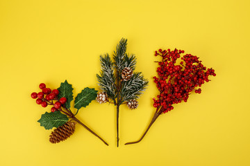 Different christmas decorations on yellow background, top view