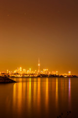 Fototapeta na wymiar View of Toronto skyline and Lake Ontario from Humber Bay Park area during night time. 