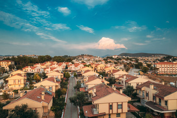 Beautiful Cityscape Of Turkish Town. White Residential Houses On Hillside. Real Estate Suburb In Summer Evening