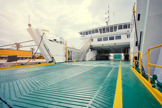 Ferryboat loading or unloading by a port pier. Concept of transportation and traveling.