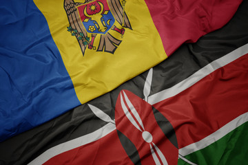 waving colorful flag of kenya and national flag of moldova.