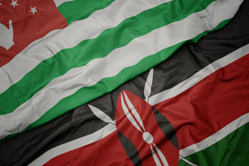 Obraz premium waving colorful flag of kenya and national flag of abkhazia.