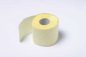 Roll of yellow toilet paper on a white background. Personal hygiene concept. Flat lay, top view