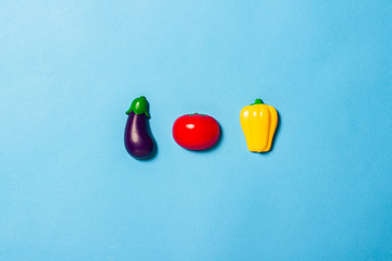Children's educational toys in the form of food on a blue background. Child development concept, kitchen for children. Artificial food, proper nutrition. Flat lay, top view