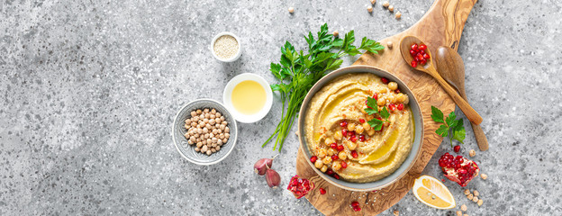 Chickpea hummus with tahini in a bowl. Healthy vegetarian appetizer. Middle Eastern cuisine. Banner - obrazy, fototapety, plakaty