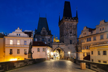 Fototapeta na wymiar Charles Bridge along is beautiful view of Old Town buildings in sunrise in Prague
