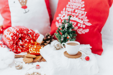 Obraz na płótnie Canvas Christmas still life, cappuccino and decorations on festive light background. Cozy winter morning