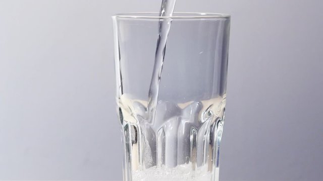 Pouring sparkling water into a glass