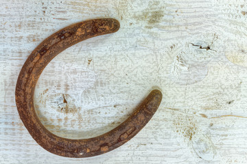Rusty Old Horse Shoe on Wood Table