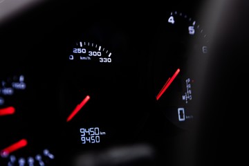 Tachometer and dashboard in a sports car.