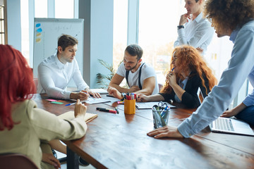 Dynamic atmosphere of efficiency and hard work, active and enthusiastic people working together creating a successful company or business. A research group working on the data they collected.