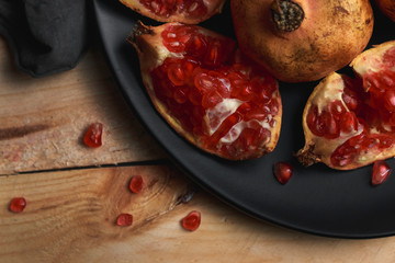 Still life of pomegranate a wooden background. Dark food concept