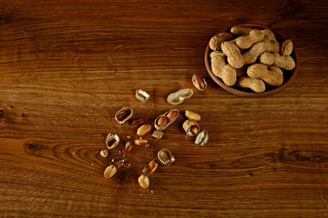 Obraz na płótnie Canvas Stylized photo peanuts on wooden background.