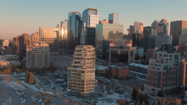 Aerial: Establishing shot of the Calgary city skyline at sunset. Calgary, Alberta, Canada. 1 April 2019