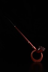 Tobacco pipe isolated on black background.