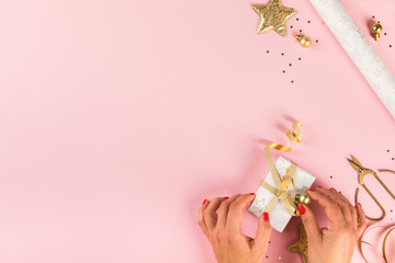 Obraz na płótnie Canvas Preparing for Christmas holidays.Female Hands Wrapping Gift Box