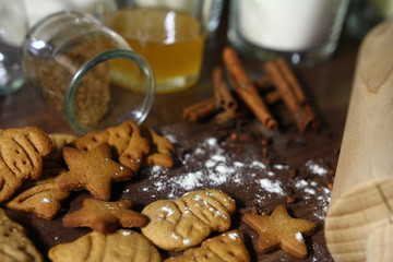 Christmas - gingerbreads on the kitchen table with cinnamon, sugar and honey