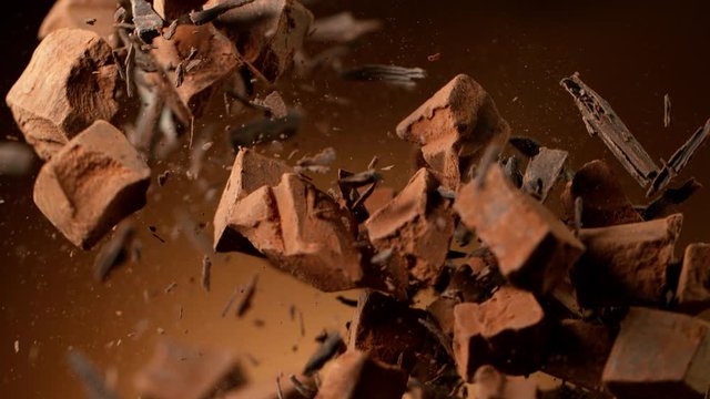 Super slow motion of flying raw chocolate pieces with ramping speed effect. Filmed on high speed cinema camera, 1000fps.