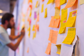 An agile software developer is updating Kanban board