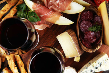 Italian antipasti wine snacks set. Cheese variety, Mediterranean olives, seafood salad, Prosciutto...