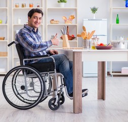 Disabled young man husband working in kitchen