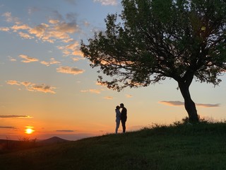 silhouette of man and woman on sunset
